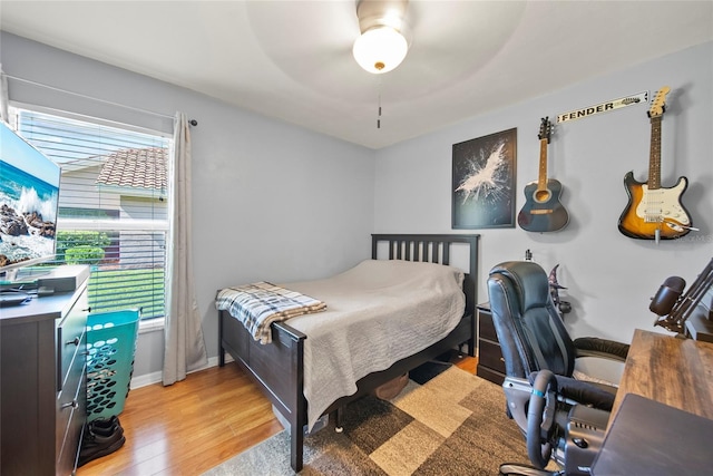 7115 39th Ln E, Sarasota, FL 34243 - bedroom featuring light wood-type flooring, multiple windows, a desk, and a ceiling fan
