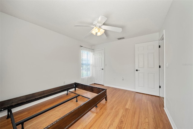 7115 39th Ln E, Sarasota, FL 34243 - unfurnished bedroom with light wood-style floors, a closet, and a ceiling fan