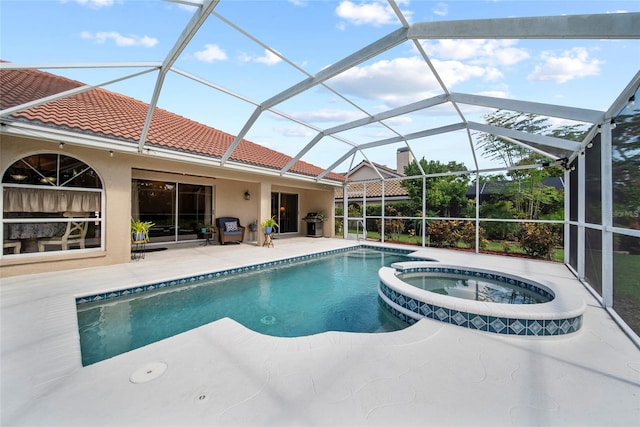 7115 39th Ln E, Sarasota, FL 34243 - view of swimming pool with a pool with connected hot tub, a patio area, and glass enclosure
