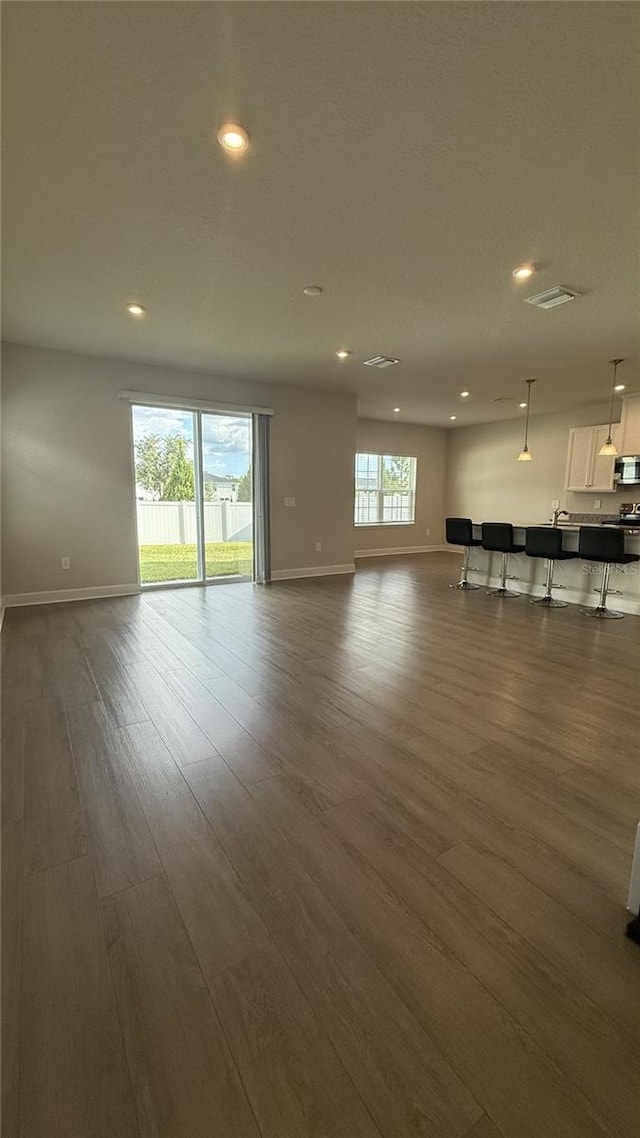 14312 Crimson Ave, Bradenton, FL 34211 - unfurnished living room featuring dark wood-type flooring and recessed lighting