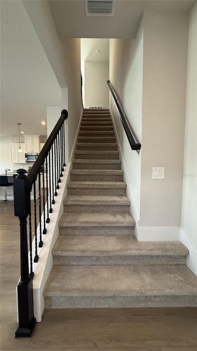14312 Crimson Ave, Bradenton, FL 34211 - stairs featuring wood finished floors and baseboards