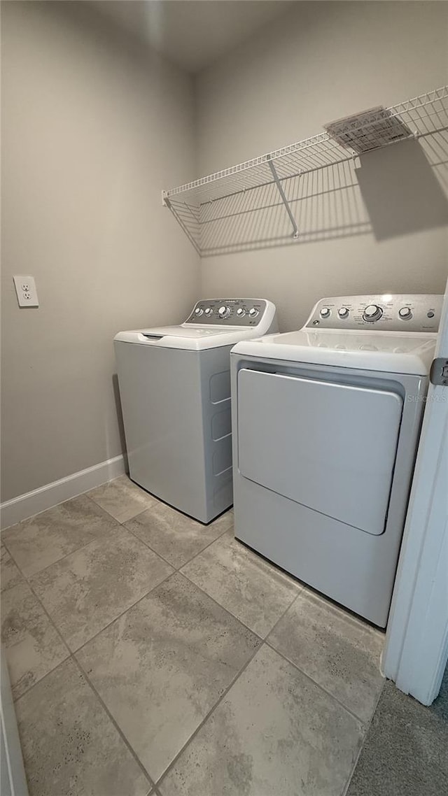 14312 Crimson Ave, Bradenton, FL 34211 - laundry room with washing machine and clothes dryer and baseboards