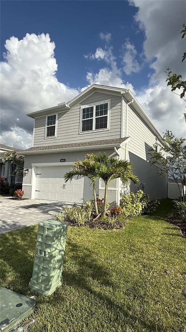 14312 Crimson Ave, Bradenton, FL 34211 - view of front facade featuring an attached garage, a front lawn, and concrete driveway