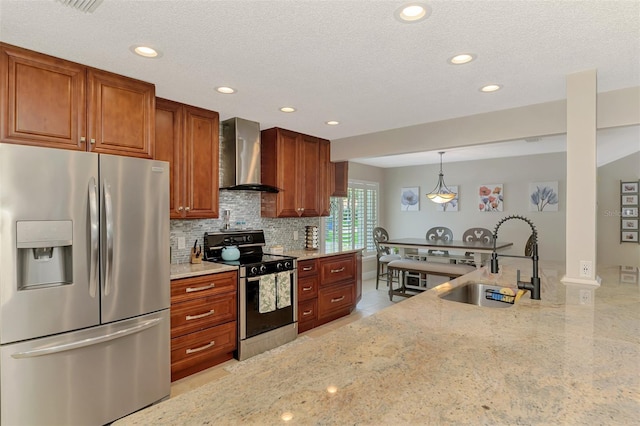 227 Monet Dr, Nokomis, FL 34275 - kitchen featuring appliances with stainless steel finishes, wall chimney exhaust hood, light stone countertops, decorative backsplash, and recessed lighting