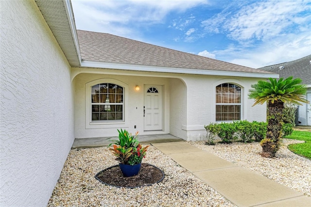7824 48th Pl E, Bradenton, FL 34203 - doorway to property featuring stucco siding and a shingled roof