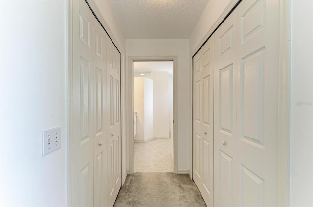 7824 48th Pl E, Bradenton, FL 34203 - hallway featuring light colored carpet and a textured ceiling