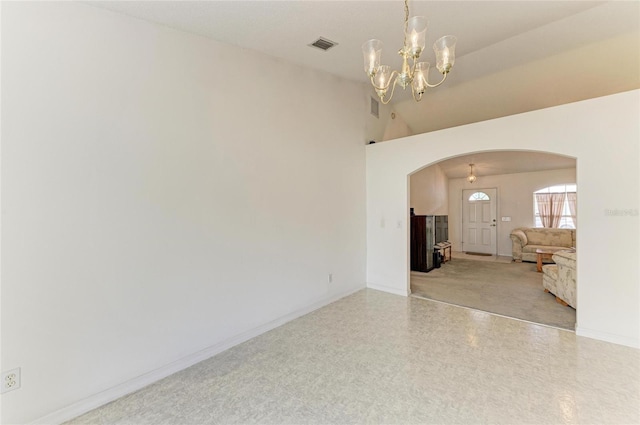 7824 48th Pl E, Bradenton, FL 34203 - unfurnished room featuring arched walkways, a chandelier, tile patterned floors, and high vaulted ceiling