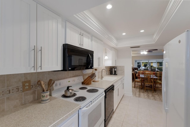 4414 Mount Vernon Dr Unit 1, Bradenton, FL 34210 - kitchen featuring black appliances, light countertops, decorative backsplash, a raised ceiling, and white cabinetry