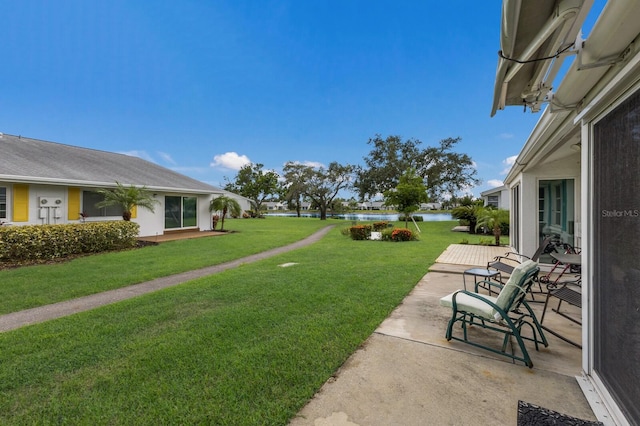 4414 Mount Vernon Dr Unit 1, Bradenton, FL 34210 - view of green lawn featuring a water view and a patio area
