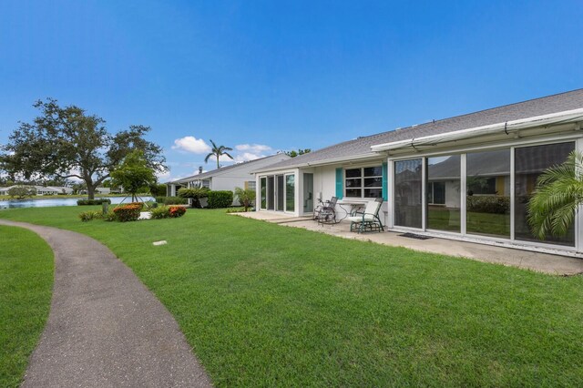 4414 Mount Vernon Dr Unit 1, Bradenton, FL 34210 - view of green lawn featuring a patio area and a water view