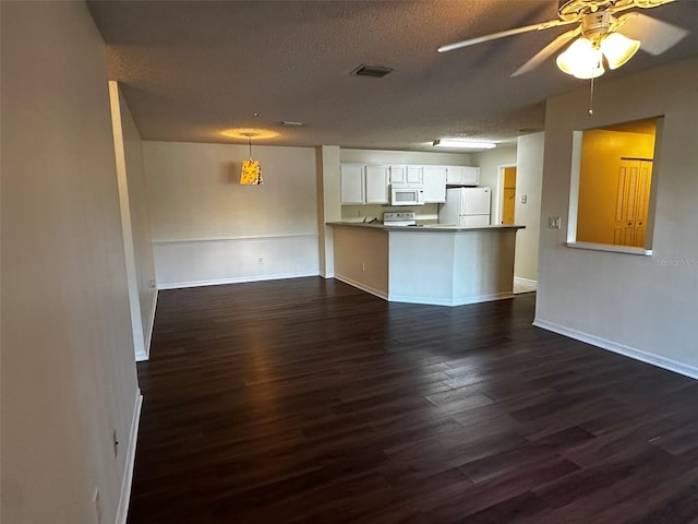 4002 Crockers Lake Blvd Unit 11, Sarasota, FL 34238 - unfurnished living room featuring dark wood finished floors, a ceiling fan, and a textured ceiling