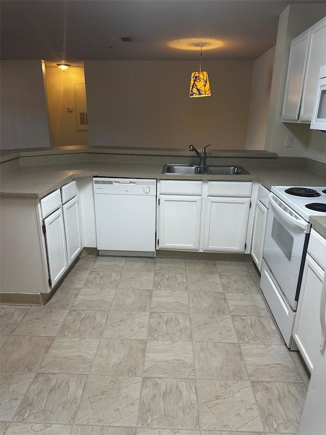 4002 Crockers Lake Blvd Unit 11, Sarasota, FL 34238 - kitchen featuring white appliances, white cabinets, and a peninsula