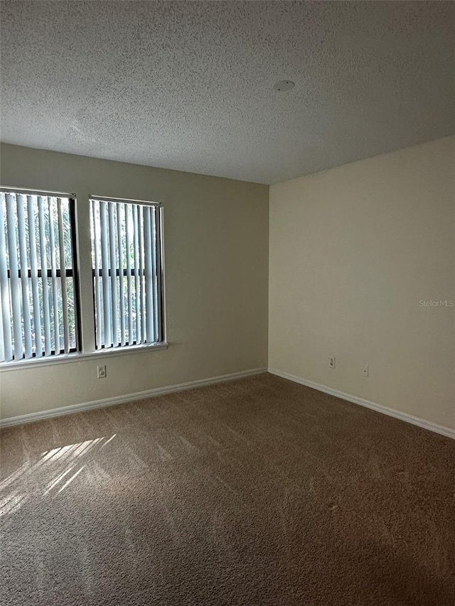 4002 Crockers Lake Blvd Unit 11, Sarasota, FL 34238 - carpeted spare room featuring a textured ceiling and baseboards