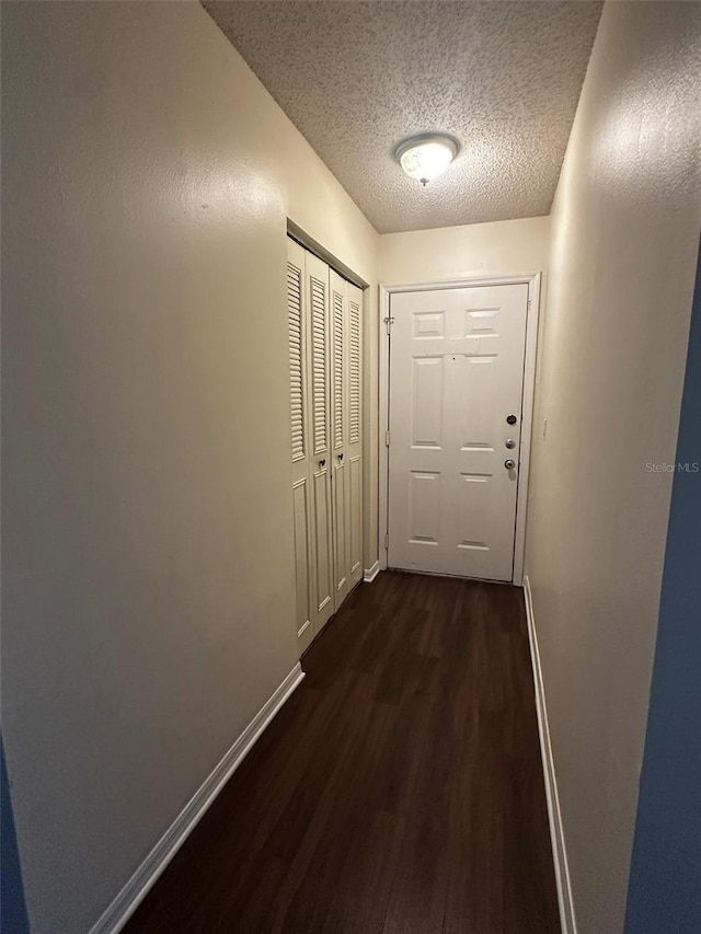 4002 Crockers Lake Blvd Unit 11, Sarasota, FL 34238 - hall featuring dark wood-style flooring and a textured ceiling