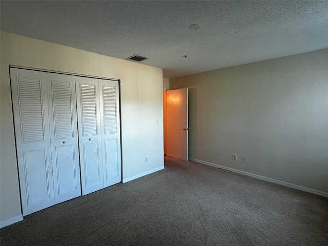 4002 Crockers Lake Blvd Unit 11, Sarasota, FL 34238 - unfurnished bedroom featuring carpet floors, a closet, and a textured ceiling