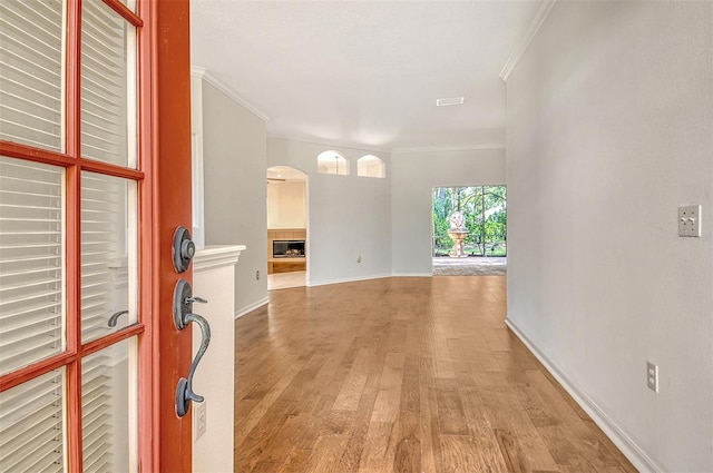 12113 Whistling Way, Lakewood Ranch, FL 34202 - foyer entrance with crown molding, light wood-type flooring, and arched walkways