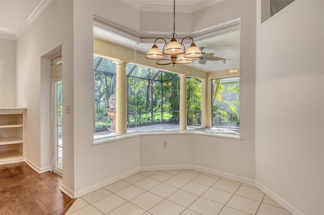 12113 Whistling Way, Lakewood Ranch, FL 34202 - unfurnished dining area featuring healthy amount of natural light, crown molding, a chandelier, and decorative columns