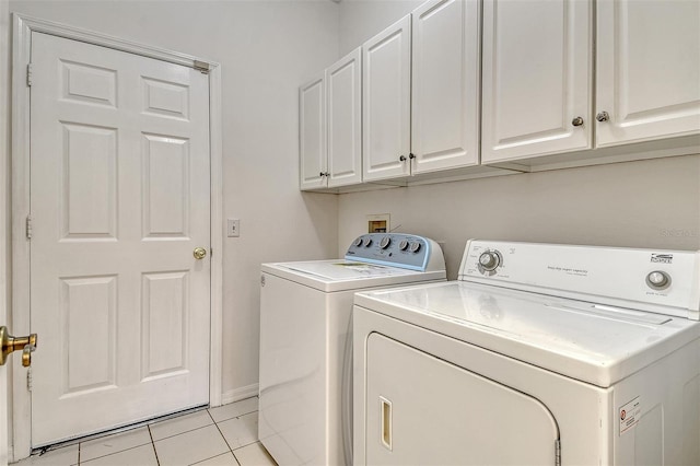 12113 Whistling Way, Lakewood Ranch, FL 34202 - laundry area with washer and clothes dryer, cabinet space, and light tile patterned flooring