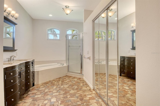 12113 Whistling Way, Lakewood Ranch, FL 34202 - bathroom with two vanities, a garden tub, a shower stall, and recessed lighting