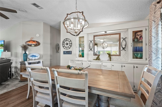 8470 Imperial Cir, Palmetto, FL 34221 - dining area featuring a textured ceiling, a chandelier, dark wood-style floors, and ceiling fan