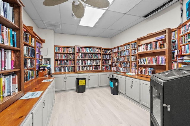 8470 Imperial Cir, Palmetto, FL 34221 - office space featuring wall of books, a paneled ceiling, light wood-style floors, and ceiling fan