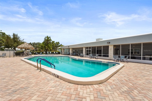 8470 Imperial Cir, Palmetto, FL 34221 - community pool featuring a patio and a sunroom