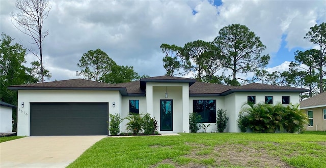 3616 Bellefonte Ave, North Port, FL 34286 - prairie-style house featuring stucco siding, a garage, concrete driveway, a front lawn, and a shingled roof