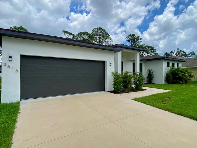 3616 Bellefonte Ave, North Port, FL 34286 - view of front of home featuring stucco siding, a garage, driveway, and a front lawn