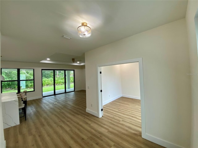 3616 Bellefonte Ave, North Port, FL 34286 - unfurnished room with wood finished floors, recessed lighting, and a tray ceiling