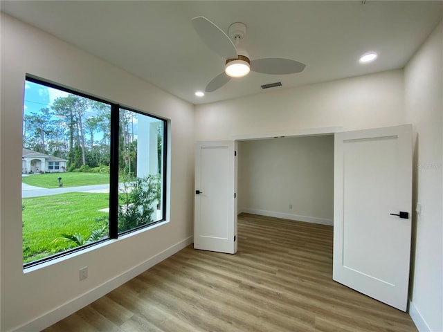 3616 Bellefonte Ave, North Port, FL 34286 - unfurnished bedroom featuring multiple windows, light wood-type flooring, recessed lighting, and ceiling fan