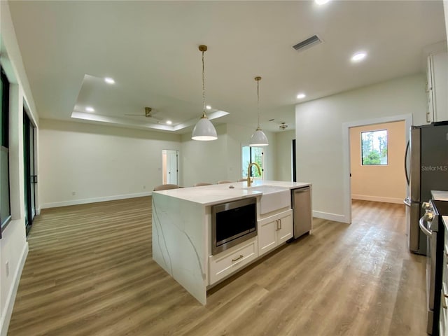 3616 Bellefonte Ave, North Port, FL 34286 - kitchen featuring appliances with stainless steel finishes, open floor plan, white cabinets, a ceiling fan, and recessed lighting