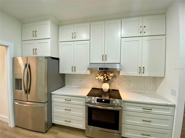 3616 Bellefonte Ave, North Port, FL 34286 - kitchen with appliances with stainless steel finishes, under cabinet range hood, white cabinets, light stone counters, and light wood-style floors