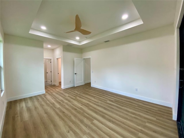 3616 Bellefonte Ave, North Port, FL 34286 - unfurnished bedroom with a tray ceiling, light wood-style flooring, recessed lighting, and a ceiling fan