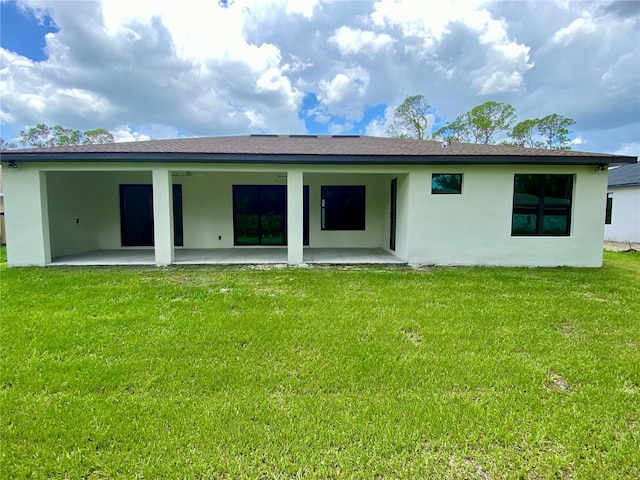3616 Bellefonte Ave, North Port, FL 34286 - back of house with a patio, stucco siding, and a yard