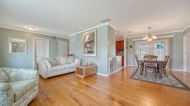 5524 Antilles Dr, Sarasota, FL 34231 - living room featuring a chandelier, light wood finished floors, and crown molding