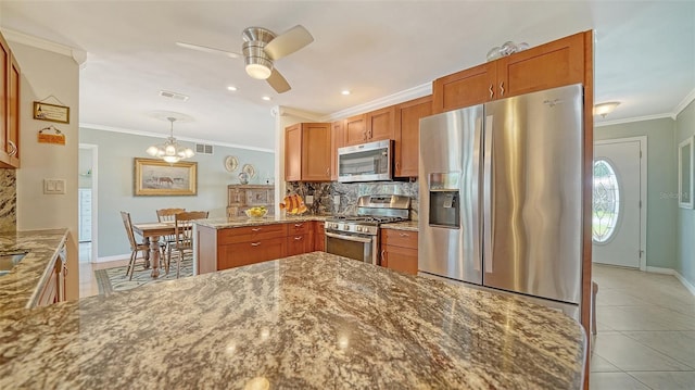 5524 Antilles Dr, Sarasota, FL 34231 - kitchen with stainless steel appliances, tasteful backsplash, crown molding, a ceiling fan, and stone counters