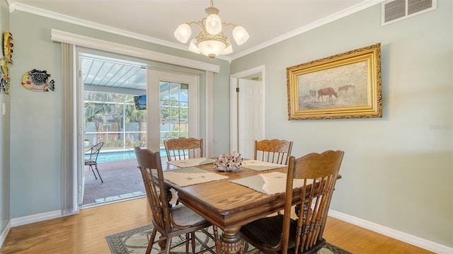 5524 Antilles Dr, Sarasota, FL 34231 - dining room with light wood-type flooring, ornamental molding, and a chandelier