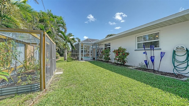 5524 Antilles Dr, Sarasota, FL 34231 - view of green lawn featuring glass enclosure and a vegetable garden