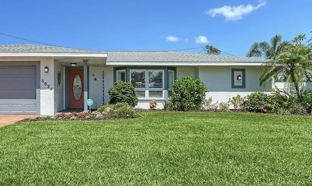 5524 Antilles Dr, Sarasota, FL 34231 - single story home with stucco siding, an attached garage, and a front yard