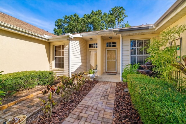 2411 New Haven Cir Unit 70, Sun City Center, FL 33573 - doorway to property featuring stucco siding