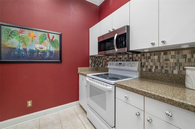 2411 New Haven Cir Unit 70, Sun City Center, FL 33573 - kitchen with electric stove, stainless steel microwave, tasteful backsplash, and light tile patterned floors