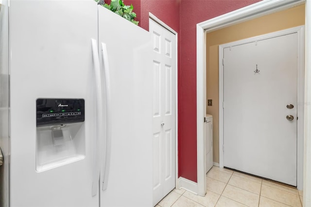 2411 New Haven Cir Unit 70, Sun City Center, FL 33573 - kitchen with white fridge with ice dispenser, light tile patterned floors, and washer / clothes dryer