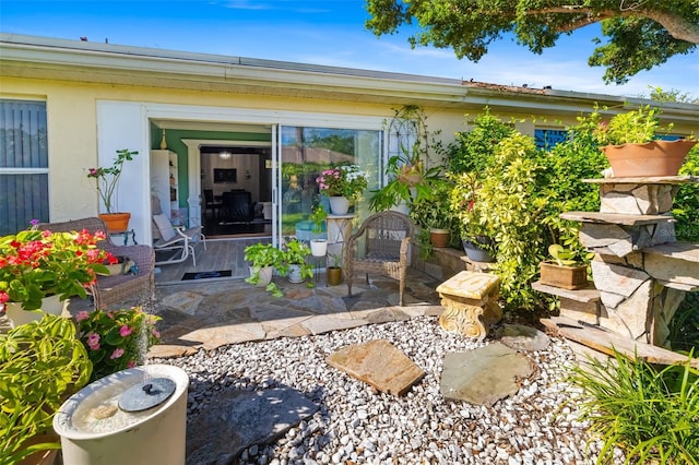 2411 New Haven Cir Unit 70, Sun City Center, FL 33573 - view of exterior entry with a patio and stucco siding