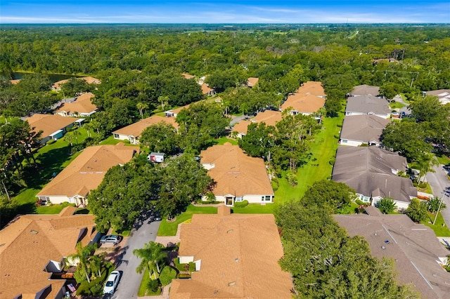 2411 New Haven Cir Unit 70, Sun City Center, FL 33573 - aerial perspective of suburban area with a heavily wooded area