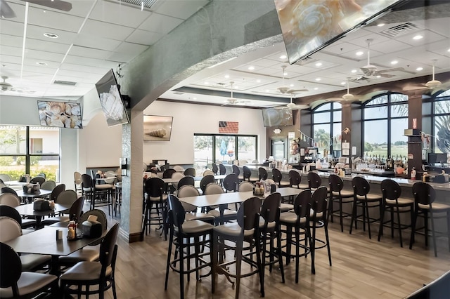 2411 New Haven Cir Unit 70, Sun City Center, FL 33573 - dining room with wood finished floors, a ceiling fan, a paneled ceiling, plenty of natural light, and recessed lighting