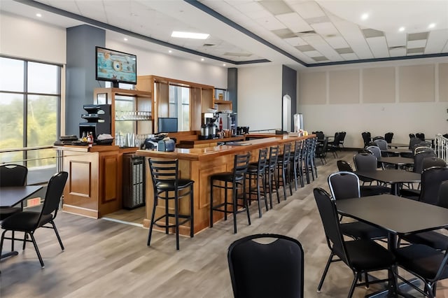 2411 New Haven Cir Unit 70, Sun City Center, FL 33573 - community bar area with light wood-style floors, a paneled ceiling, and a towering ceiling