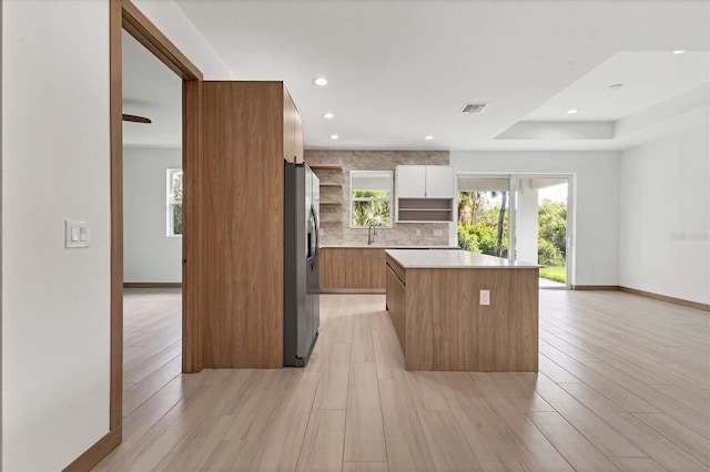 405 Sunset Rd N, Rotonda West, FL 33947 - kitchen featuring stainless steel fridge, open shelves, a kitchen island, modern cabinets, and recessed lighting