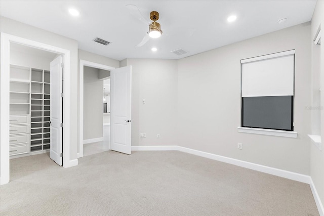 7661 Summerland Cv, Bradenton, FL 34202 - unfurnished bedroom featuring carpet floors, a walk in closet, recessed lighting, a ceiling fan, and a closet