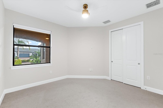 7661 Summerland Cv, Bradenton, FL 34202 - unfurnished bedroom featuring light colored carpet, a closet, and a ceiling fan