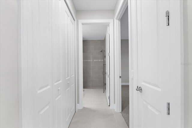 7661 Summerland Cv, Bradenton, FL 34202 - hallway featuring light tile patterned flooring and baseboards